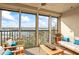 Relaxing screened in balcony with seating, coffee table, ceiling fan and expansive water views at 10355 Paradise Blvd # 1003, Treasure Island, FL 33706