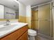 Well-lit bathroom featuring a sliding glass door shower, and tile backsplash at 10355 Paradise Blvd # 1003, Treasure Island, FL 33706