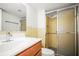Well-lit bathroom featuring a sliding glass door shower, and tile backsplash at 10355 Paradise Blvd # 1003, Treasure Island, FL 33706