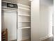 Spacious closet with shelving and a safe for secure storage of valuables at 10355 Paradise Blvd # 1003, Treasure Island, FL 33706
