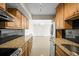Large kitchen features granite countertops, stainless steel appliances, and black backsplash at 10355 Paradise Blvd # 1003, Treasure Island, FL 33706