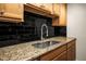 Close up on the sink, granite countertops, and maple cabinets at 10355 Paradise Blvd # 1003, Treasure Island, FL 33706
