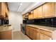 Classic kitchen featuring granite countertops, tile backsplash, and modern stainless steel appliances at 10355 Paradise Blvd # 1003, Treasure Island, FL 33706