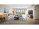 Staged living room featuring neutral tones and modern furnishings, highlighted by water views at 10355 Paradise Blvd # 1003, Treasure Island, FL 33706