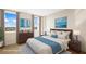 Virtually staged main bedroom featuring water views, stylish décor, and ample natural light at 10355 Paradise Blvd # 1003, Treasure Island, FL 33706