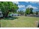 Wide backyard featuring a well-maintained lawn, mature trees, and a fenced perimeter at 10410 Ventura Ave, Tampa, FL 33619