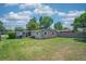 Spacious backyard with ample green space, a screen porch, and a convenient storage shed at 10410 Ventura Ave, Tampa, FL 33619