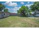 Large backyard featuring a well-maintained lawn and a sturdy wooden fence for privacy at 10410 Ventura Ave, Tampa, FL 33619