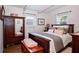 Cozy bedroom with a bed, wooden furniture, and natural light at 10410 Ventura Ave, Tampa, FL 33619
