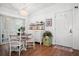 Inviting dining room showcasing wood floors, a vintage chandelier and stylish white furnishings at 10410 Ventura Ave, Tampa, FL 33619