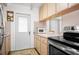 Compact kitchen featuring wood cabinets and stainless steel appliances at 10410 Ventura Ave, Tampa, FL 33619
