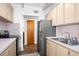 Kitchen featuring wood cabinets, stainless steel appliances, and a double basin sink at 10410 Ventura Ave, Tampa, FL 33619