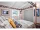 Comfortable bedroom featuring a canopy bed, closet, and natural light from the window at 10410 Ventura Ave, Tampa, FL 33619