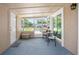 Relaxing screened-in patio with comfortable seating and a view of the neighborhood at 10410 Ventura Ave, Tampa, FL 33619