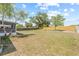 Spacious backyard with a screen porch and a wooden fence at 10538 Juliano Dr, Riverview, FL 33569