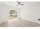 Bright bedroom with a large window, fan, and light colored floors at 10538 Juliano Dr, Riverview, FL 33569