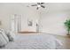 Light-filled bedroom with a ceiling fan, plant decor, and adjoining bathroom and closet access at 10538 Juliano Dr, Riverview, FL 33569