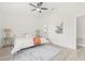 Bright bedroom featuring a ceiling fan, bedside lamps, and decor in soft, neutral tones at 10538 Juliano Dr, Riverview, FL 33569
