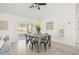 Open dining area features wood floors, contemporary lighting, and sliding glass doors to the backyard at 10538 Juliano Dr, Riverview, FL 33569
