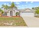 Charming single-story home with a two-car garage, well-manicured lawn, and beautiful palm trees at 10538 Juliano Dr, Riverview, FL 33569