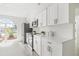 This modern kitchen features white cabinets, stainless steel appliances, and a bright, sunlit window at 10538 Juliano Dr, Riverview, FL 33569