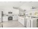 Modern kitchen with an island and stainless steel appliances, seamlessly connected to the dining and living areas at 10538 Juliano Dr, Riverview, FL 33569