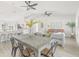 Open concept living space with bar seating, dining table, and a comfortable living room area at 10538 Juliano Dr, Riverview, FL 33569