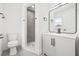 Well-lit bathroom featuring a modern vanity, toilet, and a tiled walk-in shower at 1128 Eau Claire Cir, Tampa, FL 33619