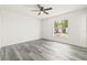 Bright, spacious bedroom with luxury vinyl flooring, a ceiling fan, and a large window at 1128 Eau Claire Cir, Tampa, FL 33619