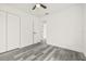 Bedroom with luxury vinyl flooring, closet, ceiling fan, and access to a bathroom at 1128 Eau Claire Cir, Tampa, FL 33619