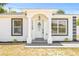 Close up of the front door with decorative glass, clean lines and well-maintained landscaping at 1128 Eau Claire Cir, Tampa, FL 33619