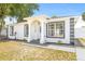 Inviting front porch with classic white columns and updated landscaping adding to the home's curb appeal at 1128 Eau Claire Cir, Tampa, FL 33619
