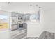 Stylish kitchen with gray cabinets, stainless steel appliances, quartz countertops, and gray wood-look flooring at 1128 Eau Claire Cir, Tampa, FL 33619