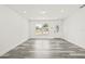 Clean living room featuring new gray wood-look floors, recessed lighting, and a view of the front door at 1128 Eau Claire Cir, Tampa, FL 33619