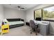 Bedroom with a trundle bed, desk, and large window offering plenty of natural light at 1139 43Rd N Ave, St Petersburg, FL 33703