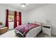 Cozy bedroom with a ceiling fan, window with curtains, and comfortable furnishings at 1139 43Rd N Ave, St Petersburg, FL 33703
