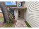 Welcoming front porch features neutral tones, updated brickwork, and beautifully manicured greenery at 1139 43Rd N Ave, St Petersburg, FL 33703
