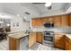 Traditional kitchen features wood cabinets, granite countertops, and stainless steel appliances at 1139 43Rd N Ave, St Petersburg, FL 33703