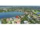 Stunning aerial view of waterfront homes along a tranquil lake, surrounded by lush greenery and mature trees at 1238 Monterey Ne Blvd, St Petersburg, FL 33704