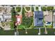 Aerial view of waterfront properties with lush landscaping, docks, and a large tree providing shade in the backyard at 1238 Monterey Ne Blvd, St Petersburg, FL 33704