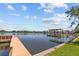 A wooden dock with a covered boat lift providing direct water access and scenic views at 1238 Monterey Ne Blvd, St Petersburg, FL 33704