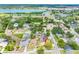 Aerial view of a neighborhood with a lake and waterways, lush greenery, and residential homes at 12470 93Rd St, Largo, FL 33773