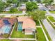 Aerial view of the home highlighting the screened pool, large yard, landscaping, and storage shed at 12470 93Rd St, Largo, FL 33773