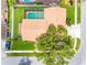 Birds eye view of home with tile roof, a screened pool, green yard, and mature trees at 12470 93Rd St, Largo, FL 33773