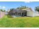 Spacious backyard featuring an enclosed swimming pool and storage shed on a lush lawn at 12470 93Rd St, Largo, FL 33773