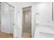 Bathroom with walk-in glass shower, white cabinets and drawers, gold hardware, and wood flooring at 12470 93Rd St, Largo, FL 33773