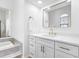 Bright bathroom featuring double vanity, modern fixtures, and large soaking tub at 12470 93Rd St, Largo, FL 33773