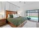 Bright bedroom featuring a wooden bed and a sliding door leading to the beautiful outdoor swimming pool at 12470 93Rd St, Largo, FL 33773