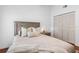 Bedroom featuring warm hardwood floors, a modern lamp on the nightstand, and a cozy comforter at 12470 93Rd St, Largo, FL 33773