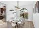 Dining room featuring a modern glass-top table, stylish chairs, and a wine rack at 12470 93Rd St, Largo, FL 33773